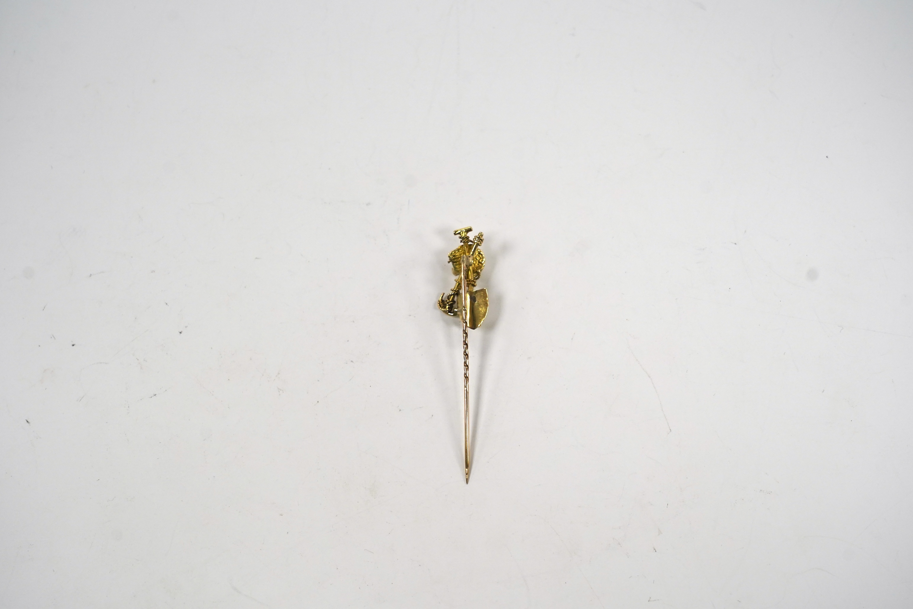 An early 20th century 9ct and diamond set 'Australian miner's' stick pin, 63mm, 4 grams.